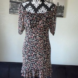 Floral smocked dress featuring off shoulder sleeves and a flared hem.